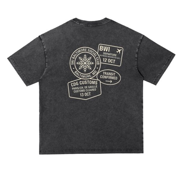 The Transit Tee in black, a vintage-wash cotton T-shirt with a travel-inspired customs stamp design